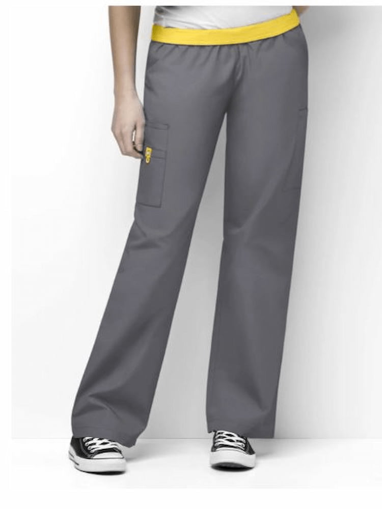 A middle aged female Medical Assistant wearing a pair of the WonderWink Women's Elastic Waist Scrub Pants in Pewter size 2XL featuring a fully elastic waistband that can be flipped down.