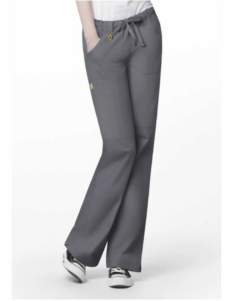 A young female Physician's Assistant wearing a WonderWink Origins Women's Tango Utility Scrub Pant in Pewter size 3XL featuring a total of 7 pockets.