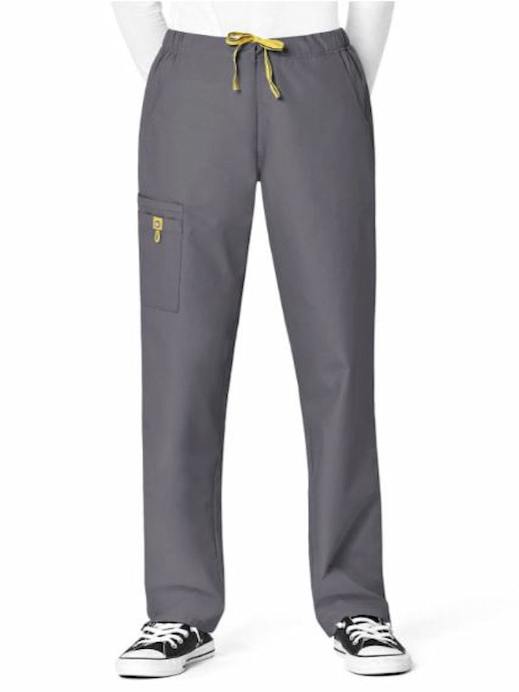 A young female Nursing Assistant wearing a WonderWink Women's Slim Leg Cargo Scrub Pant in Pewter size XL featuring one WonderWink signature triple cargo pocket with ID bungee loop and hidden mesh cell pocket.