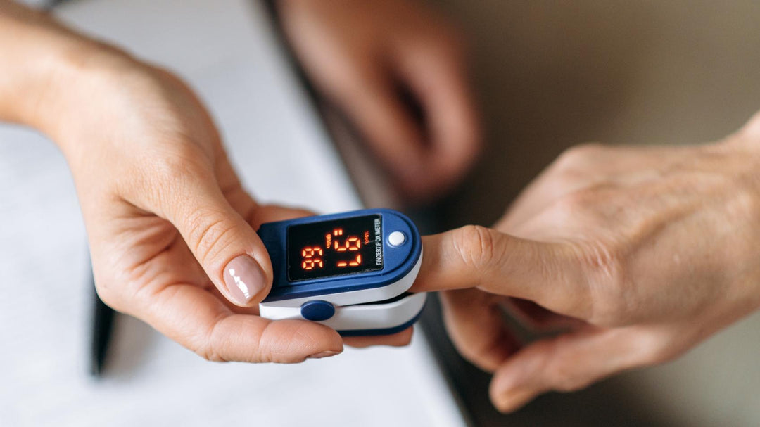 A medical professional using a fingertip pulse oximeter from Scrub Pro Uniforms  on a patient.