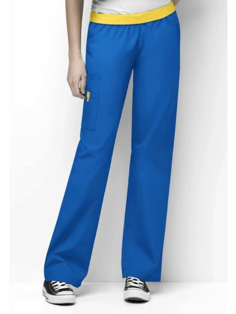 A female Physical Therapist wearing a Women's Quebec Fully Elastic Waistband Cargo Pant from WonderWink Origins in Royal size Small featuring a signature ID bungee loop at wearer's right side.