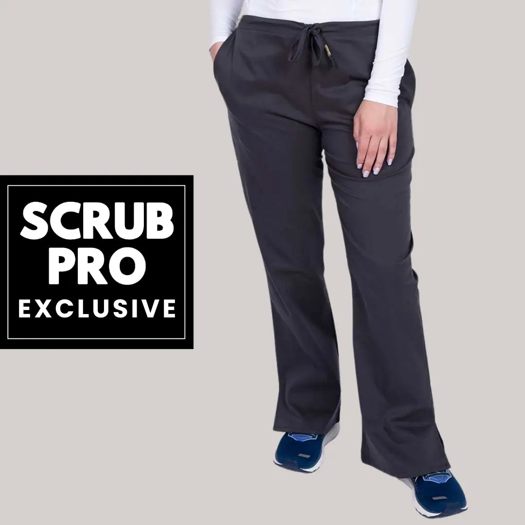 A young female lab tech showcasing one of the available styles in Scrub Pro Uniforms' collection of Exclusive Women's Scrub Pants on a light grey background.