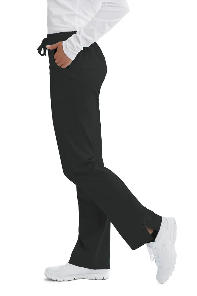 The left side of the Skechers Women's Reliance Cargo Scrub Pants in Black featuring side vents at the ankle for easy removal.