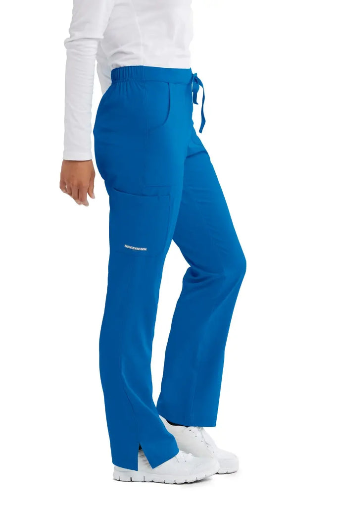The right side of the Skechers Women's Reliance Cargo Scrub Pant in New Royal featuring a cargo pocket with the Skechers logo printed on the bottom of the pocket.
