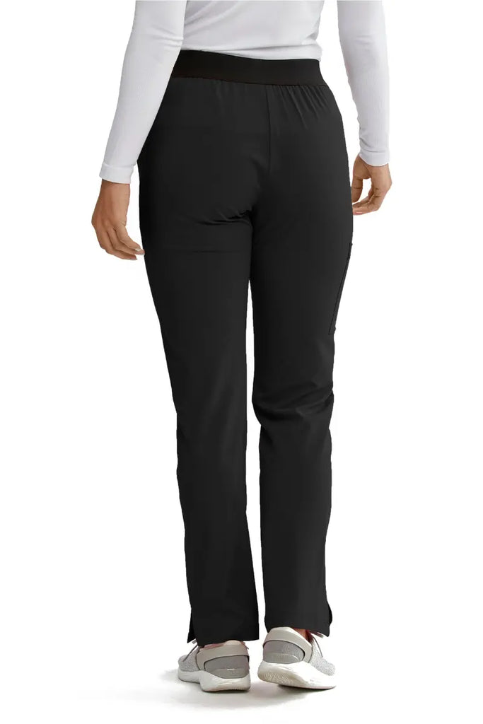 The back of the Skechers Women's Vitality Scrub Pant in Black size Small featuring ankle vents for easy slip-on and removal.