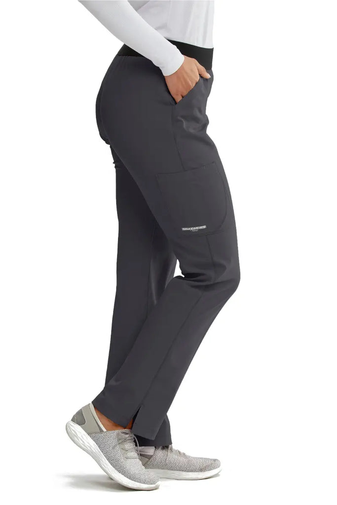 The right side of the Skechers Women's Vitality Scrub Pant in Pewter size Medium featuring an outside cargo pocket with the Skechers logo printed on the bottom.