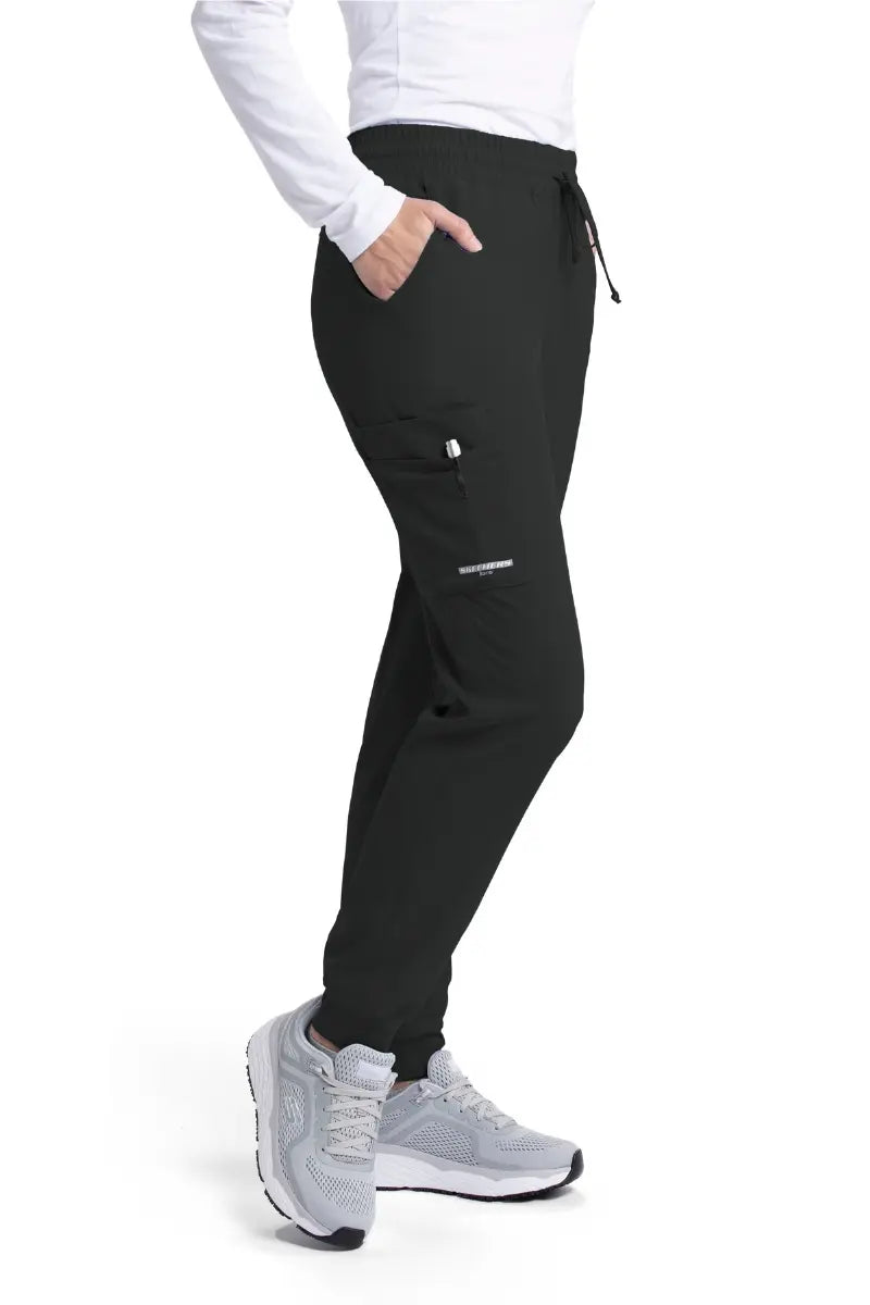 The right side of the Skechers Women's Theory Scrub Jogger in Black featuring an exterior cargo pocket with the Skechers' logo printed on the bottom of the pocket.