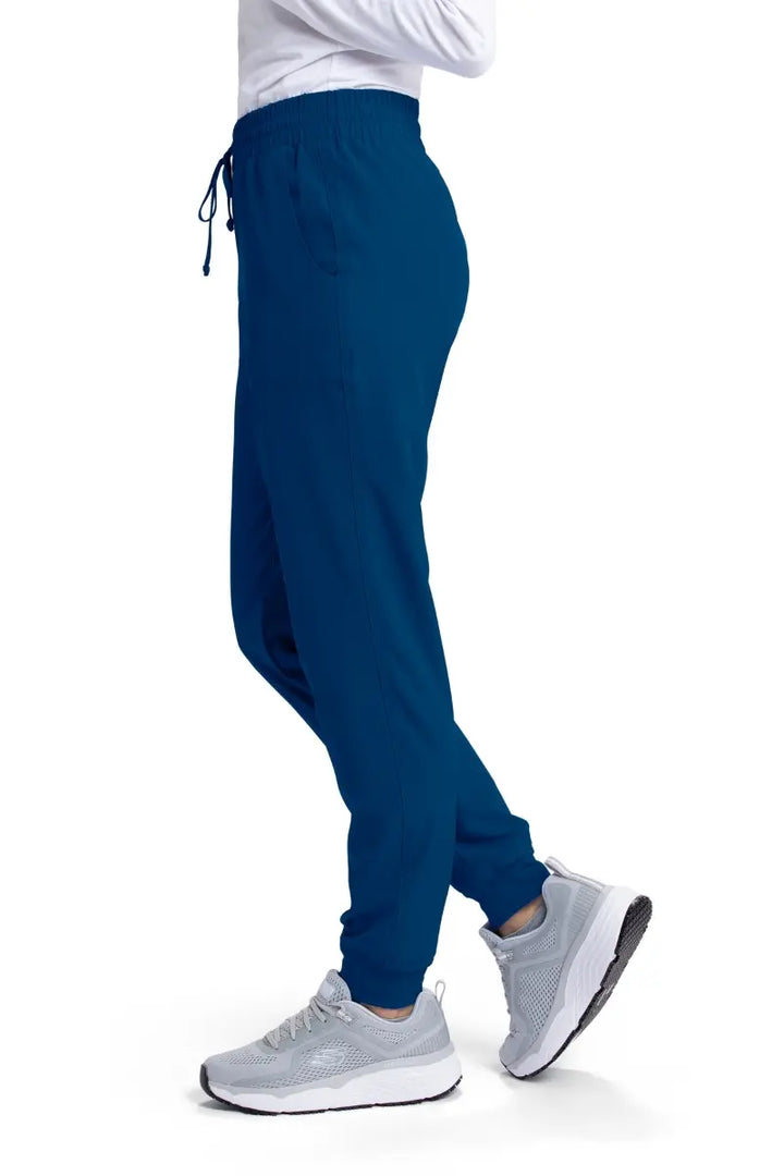 The left side of the Skechers Women's Theory Scrub Jogger in Navy Blue featuring a drawstring waistband.