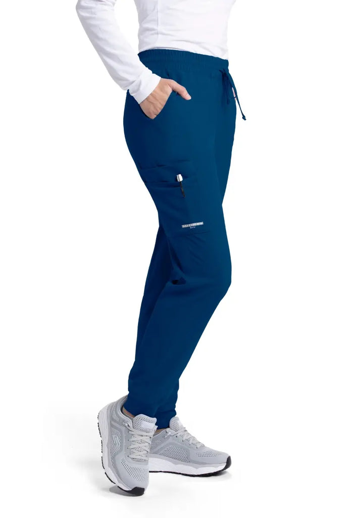 The right side of the Skechers Women's Theory Scrub Joggers in navy featuring an exterior cargo pocket on the wearer's right side leg.