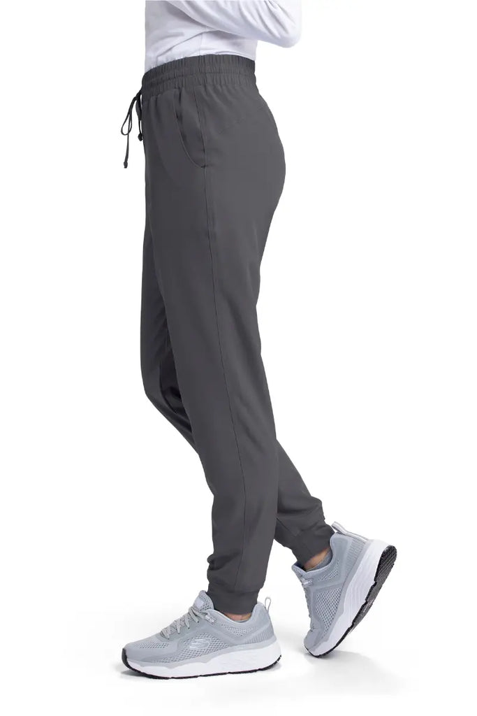 The left side of the Skechers Women's Theory Scrub Jogger in Pewter size XS featuring a drawstring waistband.