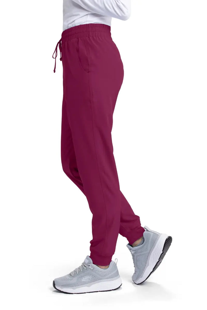 The left side of the Skechers Women's Theory Jogger Scrub Pant in Wine featuring a drawstring waistband.