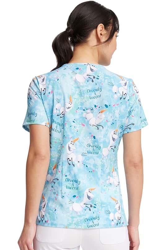 A young Home Care Registered Nurse wearing a Tooniforms Women's V-Neck Print Scrub Top in "Obviously a Unicorn" featuring a center back length of 26.5".