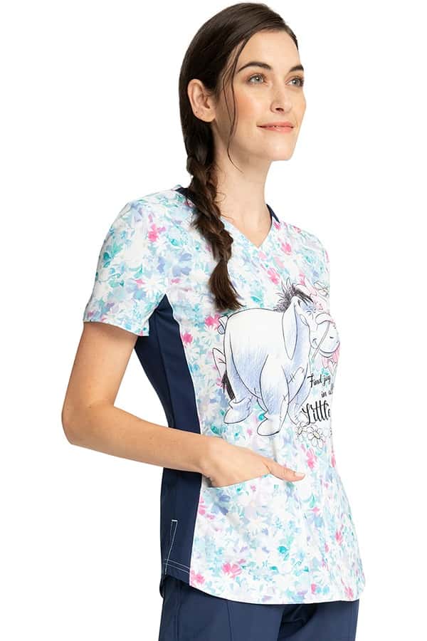 Female nurse wearing a Cherokee Tooniforms Women's V-Neck Print Top in "Find Joy" featuring a unique 4-way stretch fabric.
