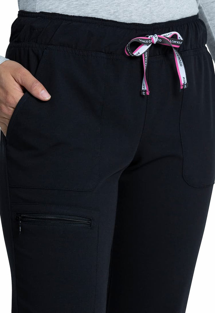 A young female Pharmacy Technician wearing a Vince Camuto Women's Mid Rise Drawstring Jogger in Black size XS Tall featuring an adjustable drawstring to ensure a comfortable all day fit.