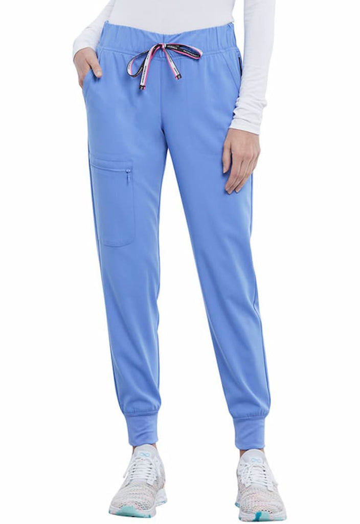 A young female Nursing Assistant wearing a Vince Camuto Women's Mid Rise Drawstring Jogger in Ceil size Medium Petite featuring a relaxed fit.