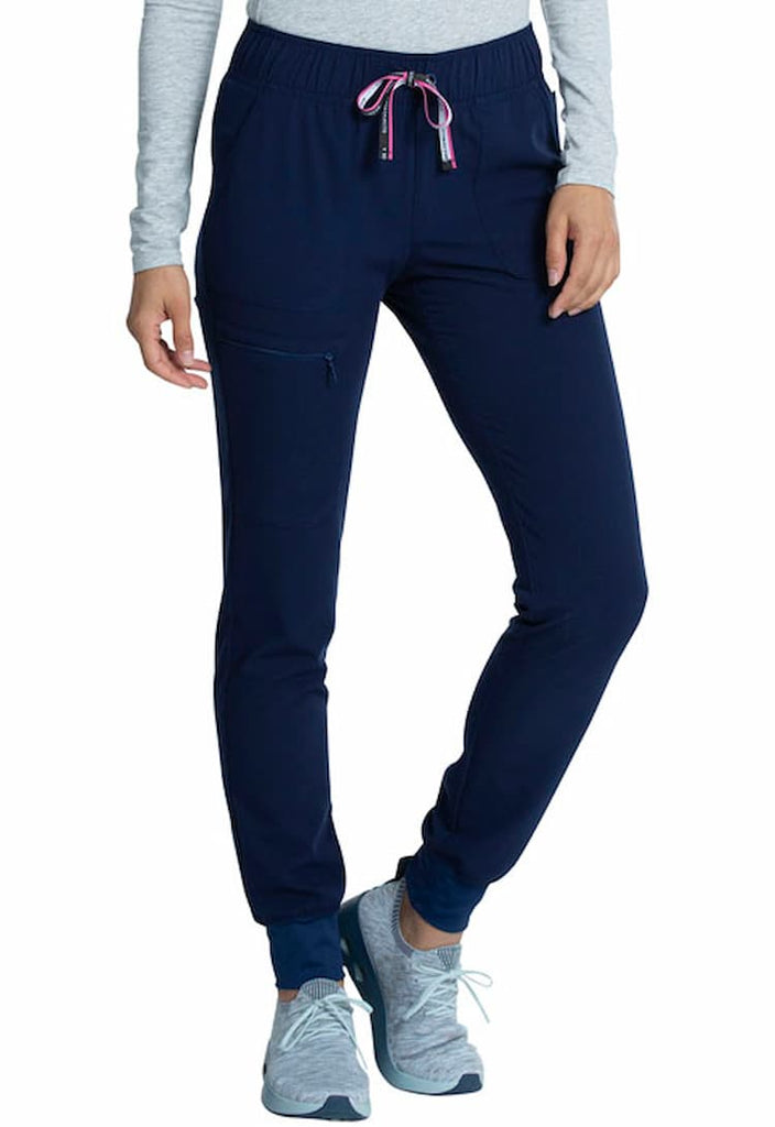 A young female Nursing Assistant wearing a Vince Camuto Women's Mid Rise Drawstring Jogger in Navy size Large Petite featuring a relaxed fit.