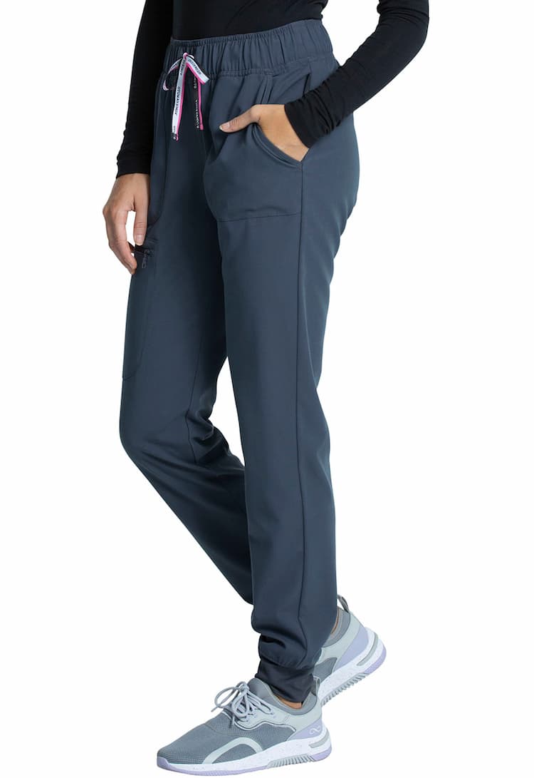 An image of a young female Physical Therapist wearing a Vince Camuto Women's Mid Rise Drawstring Jogger in Pewter size Small Tall featuring an inseam of roughly 29".