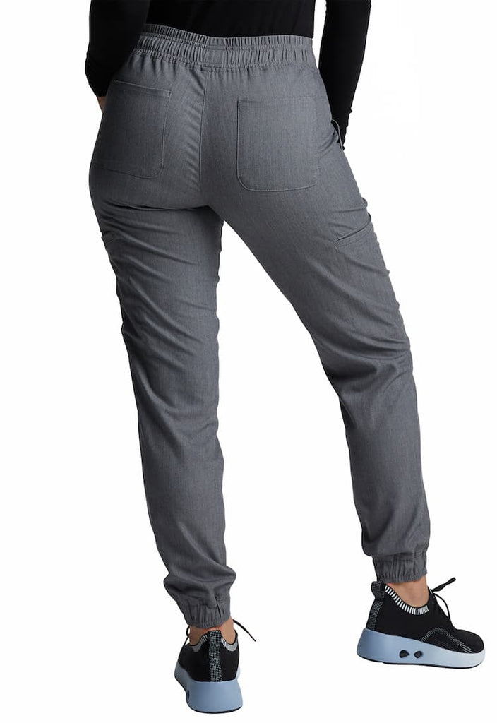 A young female Registered Nurse wearing a Vince Camuto Women's Mid Rise Jogger in Heathered Charcoal size 3XL featuring 2 back patch pockets.
