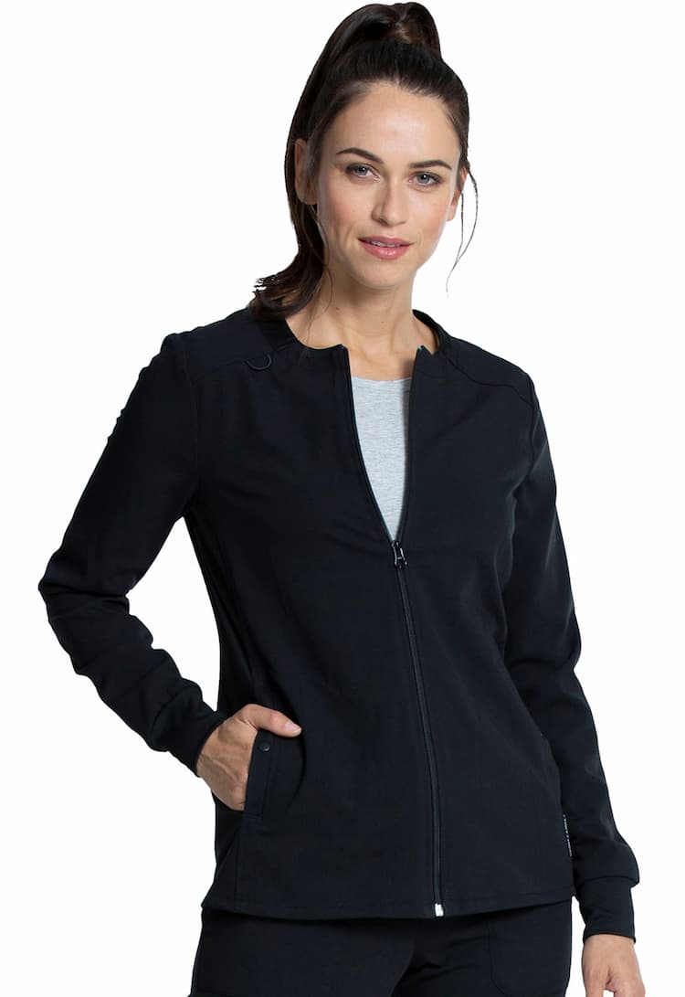 A young female Physician's Assistant wearing a Vince Camuto Women's Zip Front Scrub Jacket in Black size 3xl featuring a total of 3 pockets.