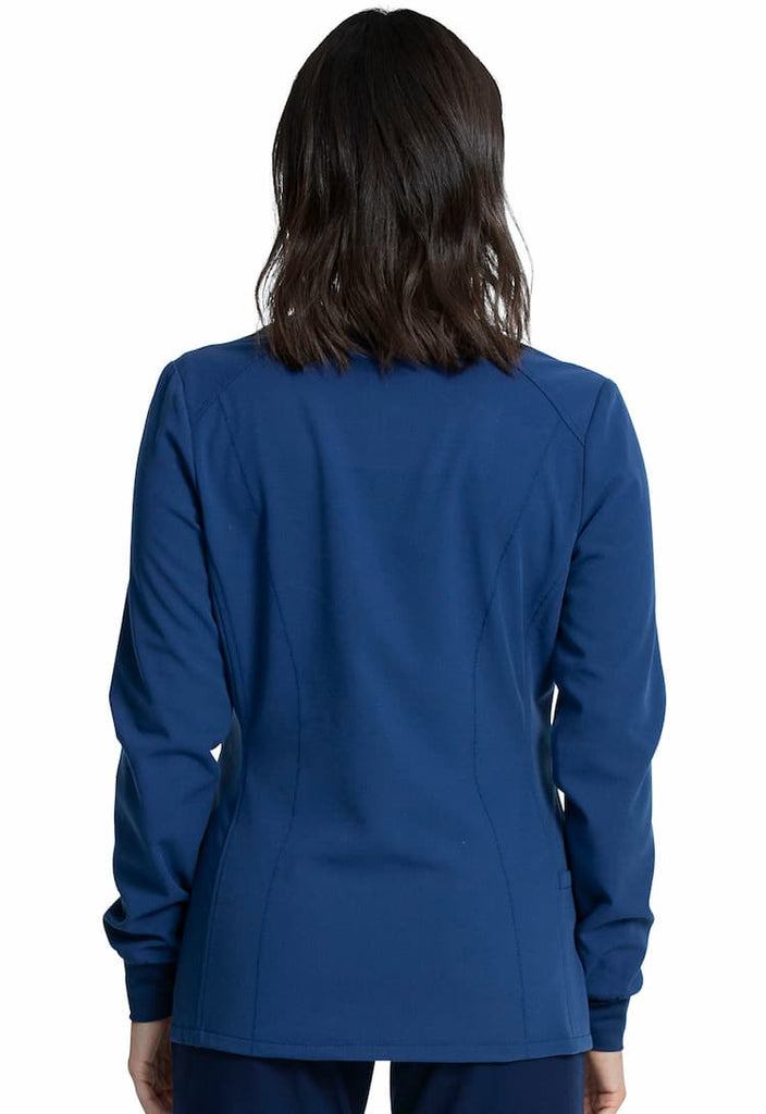 An image of a female Dental Assistant wearing a Vince Camuto Women's Zip Front Scrub Jacket in Navy size Small featuring princess seams at the front & back.