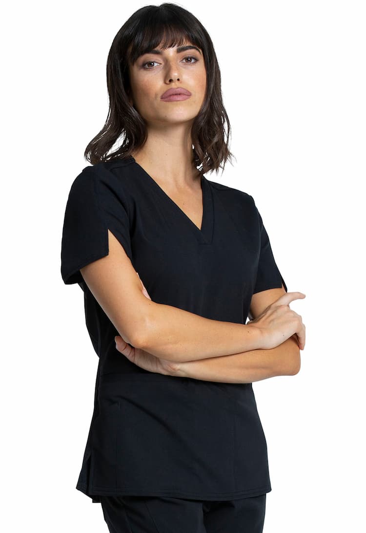 A female Nurse Practitioner wearing a Vince Camuto Women's V-neck Scrub Top in Black size Medium featuring a relxed hem to ensure comfortbale yetpofssional look & feel all day long.