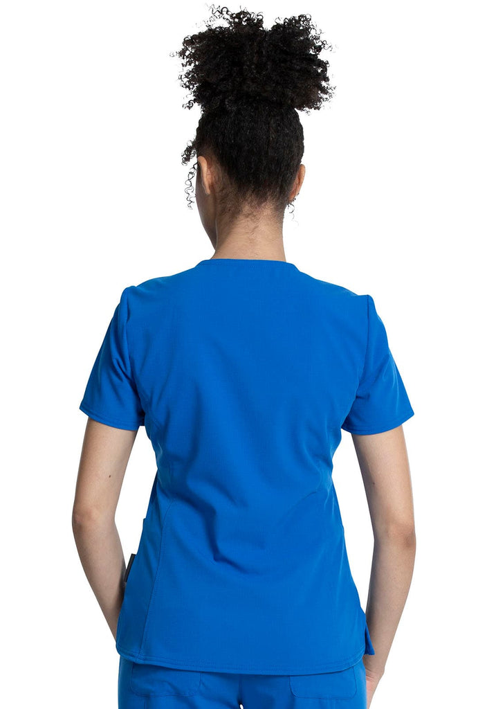 An image of a young female Physical Therapist wearing a Vince Camuto Women's V-Neck Scrub Top in Royal Blue size Medium featuring a center back length of 26". 