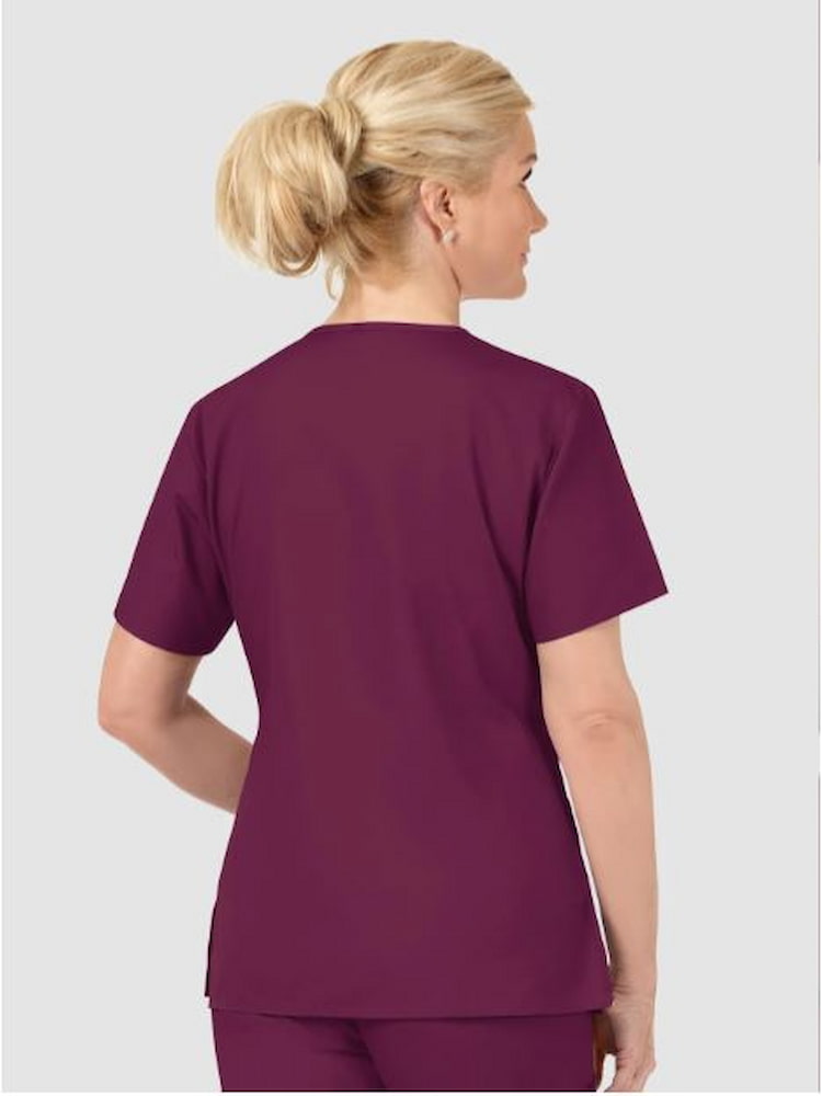 An image of the back of a female Pharmacist wearing a WonderWink Origins Women's Bravo V-neck Scrub Top in Wine size 2XL featuring  vented sides.