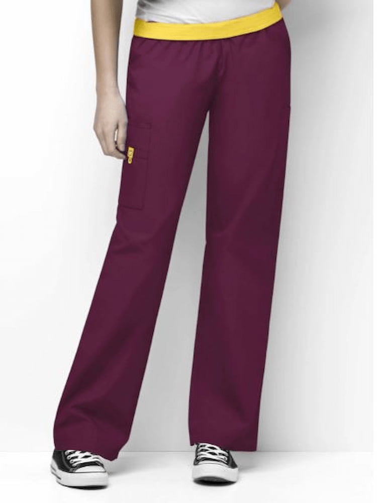A female Diagnostic Medical Sonographer wearing a pair of WonderWinkn Women's Elastic Waist Scrub Pants in Wine size Medium Tall featuring a boot cut leg.