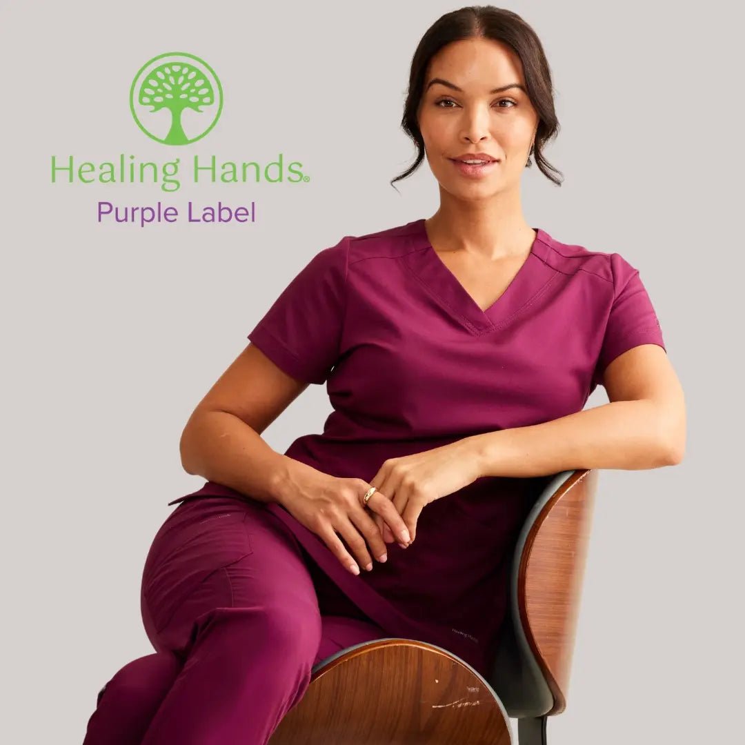 A close look at a Psychiatric Nurse wearing Wine scrubs from Healing Hands Purple Label on a light grey background.