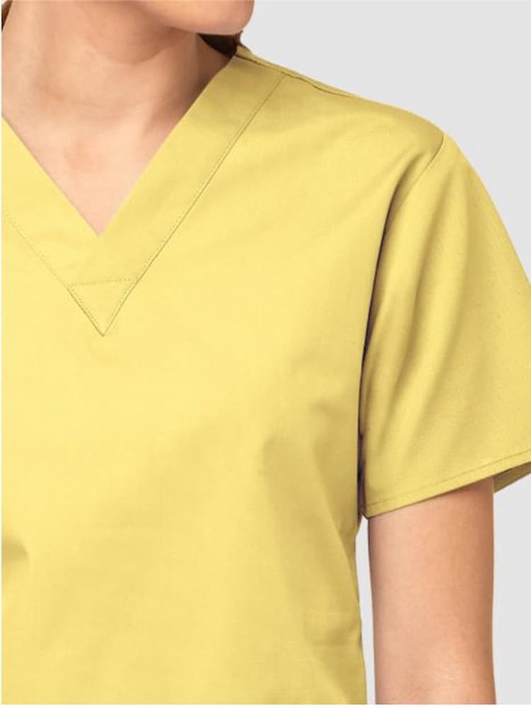 A close up photograph of the v-neckline of the WonderWink Origins Women's Bravo V-neck Scrub Top in Yellow size medium.