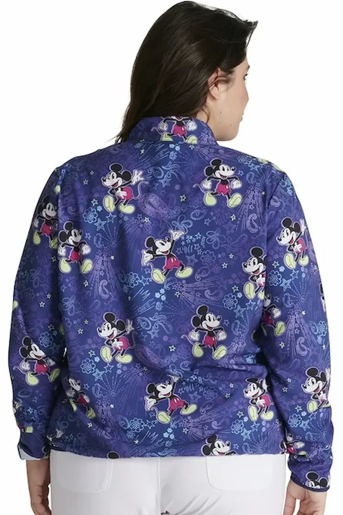 A young female Neonatal Nurse wearing a Tooniforms Women's Packable Print Scrub Jacket in "Mickey's Bandana Land" size 3xl featuring a center back length of 23.5".