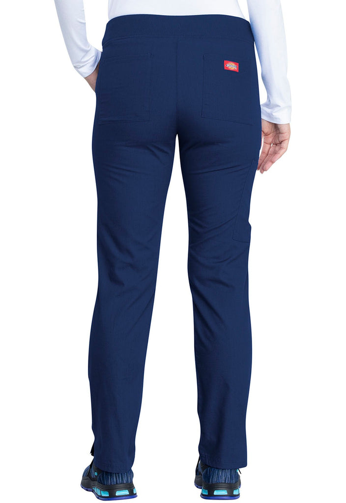 A young female Healthcare Professional wearing a Dickies EDS Signature Women's Mid Rise Pull-on Pant in Navy  size XS Petite featuring 2 back patch pockets for additional on the go storage needs.