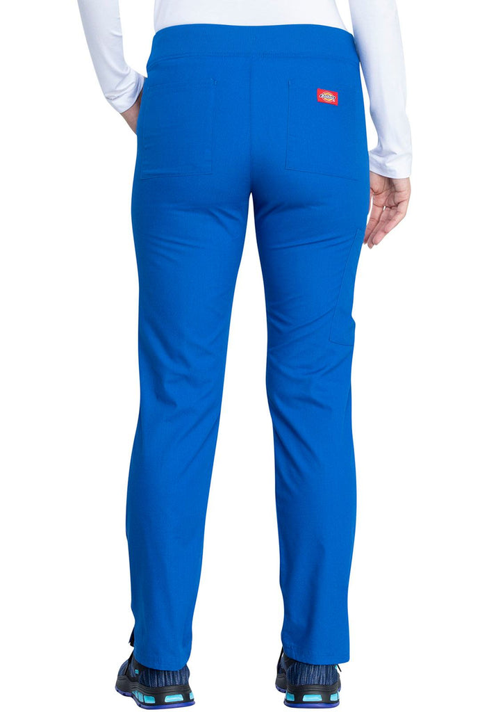 A young female Healthcare Professional wearing a Dickies EDS Signature Women's Mid Rise Pull-on Pant in Royal size XS featuring 2 back patch pockets for additional on the go storage needs.