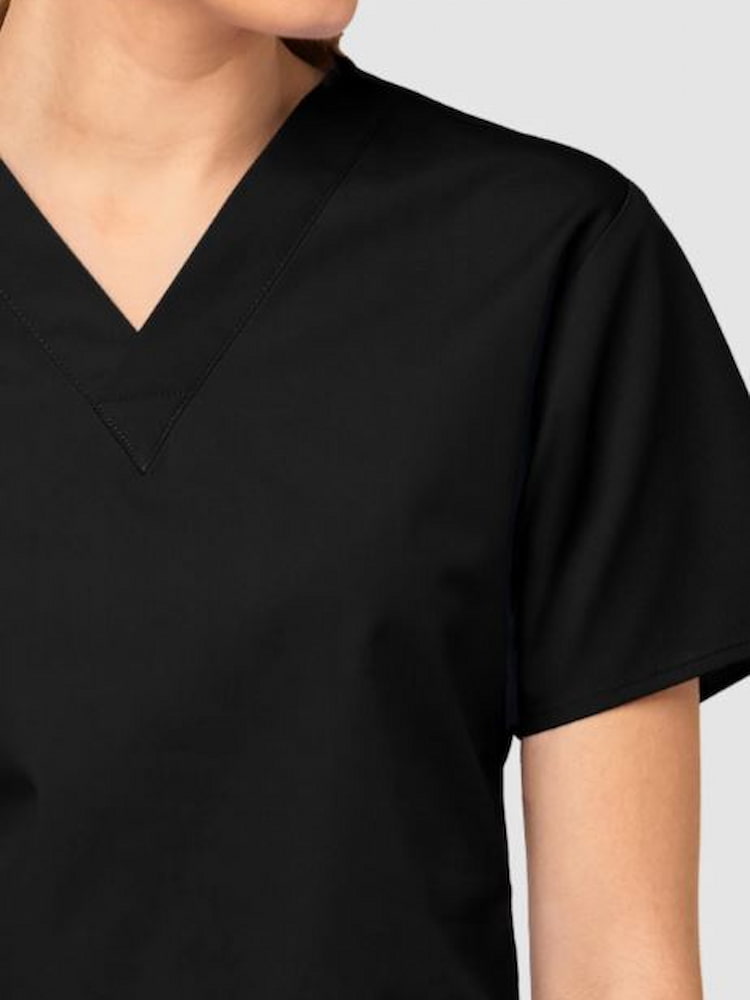 An up close image of the V-neckline from the WonderWink Origins Women's Bravo 5 Pocket Scrub Top in Black size 3XL.