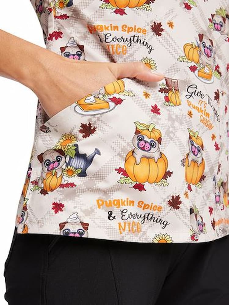 An up close shot of the right side front patch pocket on the Cherokee Women's V-Neck Printed Scrub Top in "Pugkin Spice"  size Large.