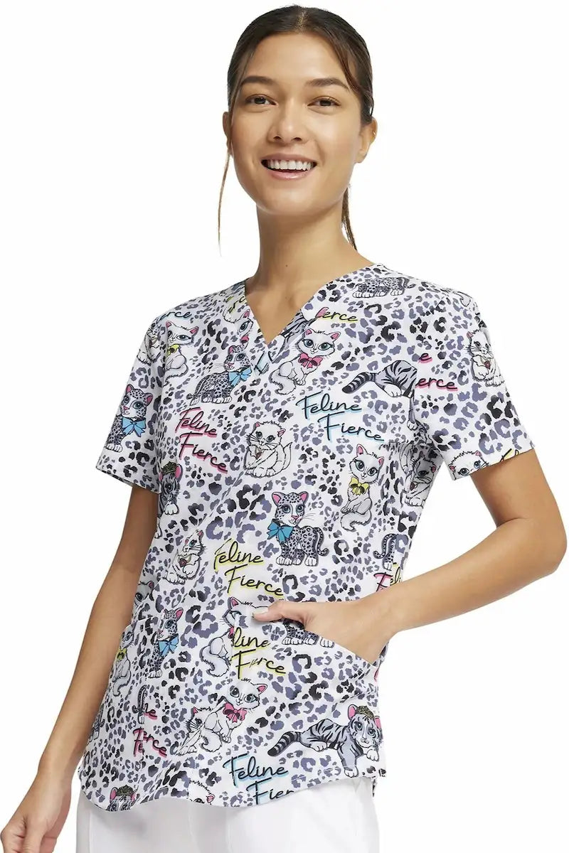 A look at the left side of the Cherokee Women's V-Neck Print Scrub Top in "Feline Fierce" featuring two front patch pockets.