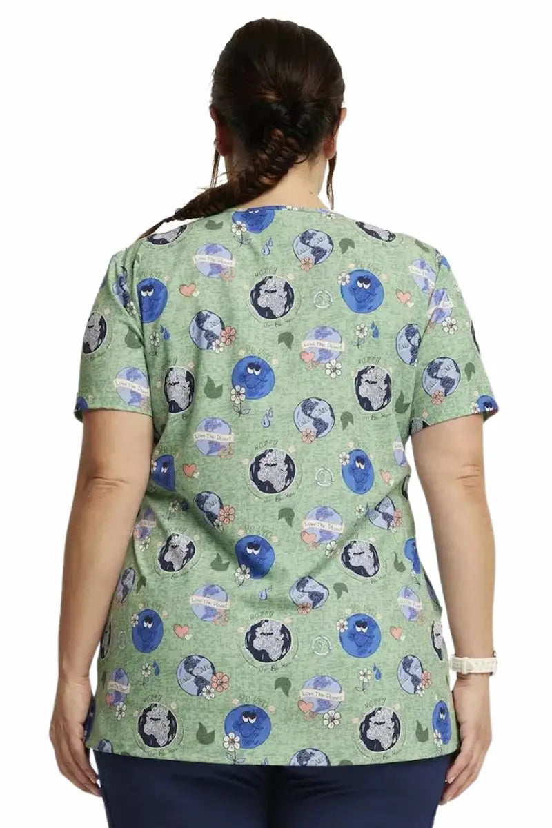 The back of the Dickies Women's V-Neck Print Scrub Top in "Happy To Be Here" featuring a center back length of 27".