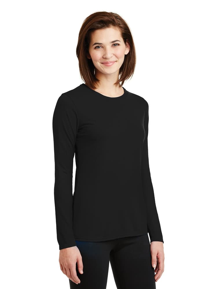 A young female EMT wearing a Flexibilitee Women's Crew Neck Long Sleeve T-Shirt in Black size XL on a solid, white background.
