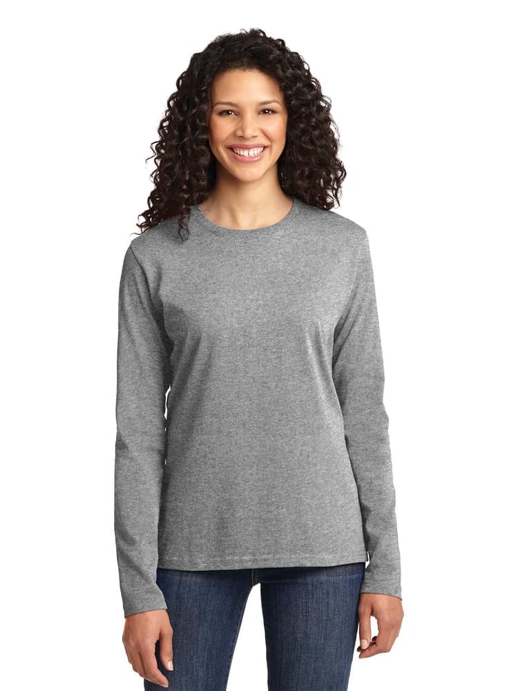 A young female RN wearing a Flexibilitee Women's Crew Neck Long Sleeve Tee in "Heather grey" size XL featuring a crew neckline, long sleeves & sSide seams for a contoured body & flattering fit.