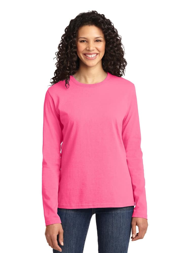A young female wearing a Flexibiltee Women's Crew Neck Long Sleeve Tee in Pink Lemonade size 2xl featuring a crew neckline with a tag-less inside to ensure a comfortable all day fit.