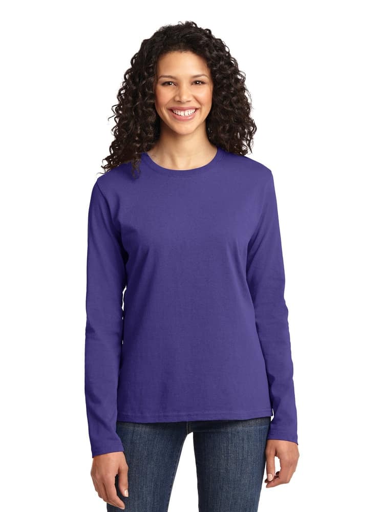 A young female Nurse practitioner wearing a Flexibilitee Women's Crew Neck Long Sleeve Tee in Purple size Large featuring a rib knit collar with a tag-less neckline to provide unmatched all day comfort.