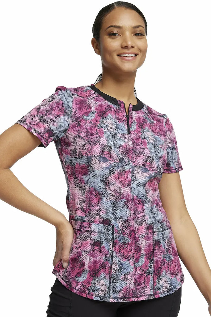 A young female Psychiatric Nurse wearing a Cherokee Infinity Women's Round Neck Printed Scrub Top in "Hiss or Miss" size Large featuring a contemporary fit.