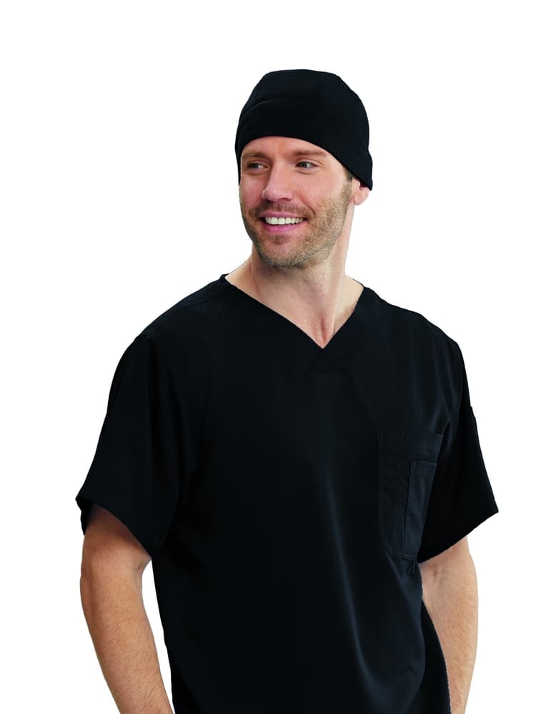 A young Male Surgeon wearing a Grey's Anatomy Fitted Scrub Cap in Black featuring contoured seaming throughout.