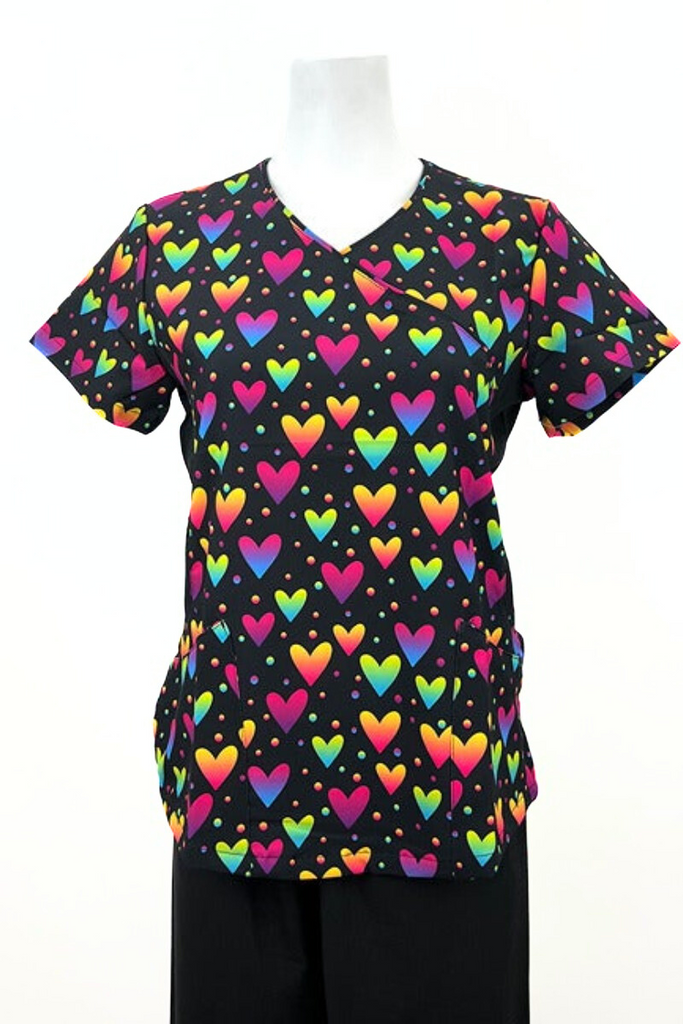 A frontward facing image of the Women's Mock Wrap Print Scrub Top from Revel Premium Stretch featuring a mock wrap neckline, short sleeves & 2 front patch pockets.