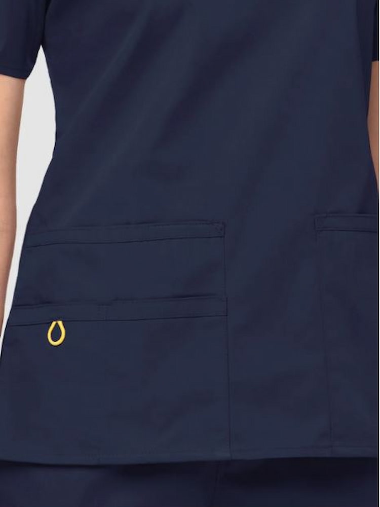 An up close image of the two lower front patch pockets on the WonderWink WOmen's Bravo V-neck 5 Pocket Scrub Top in Navy size Medium.