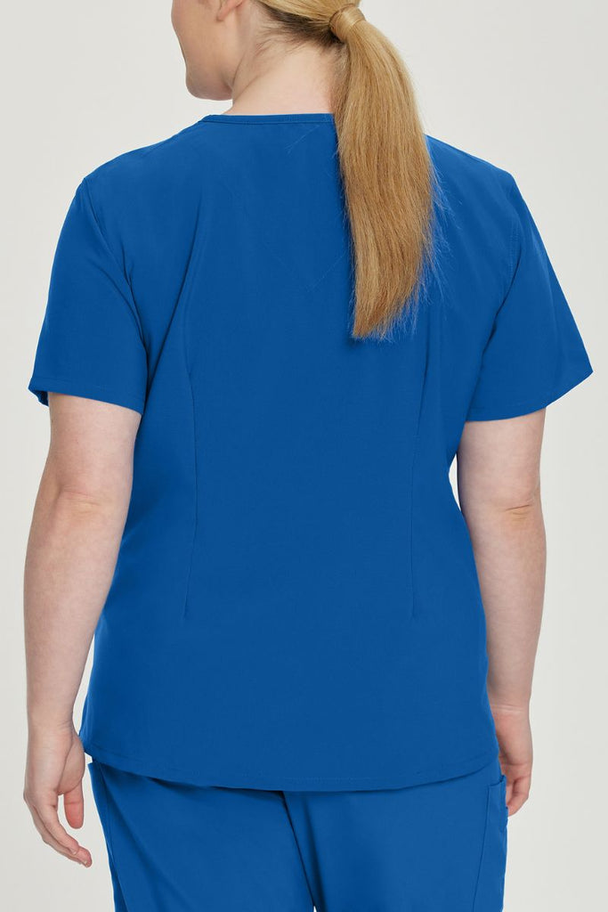 A young female Medical Assistant wearing an Urbane Performance Women's Motivate V-neck Scrub Top in New Royal size 2XL featuring a unique, 4-way stretch fabric.