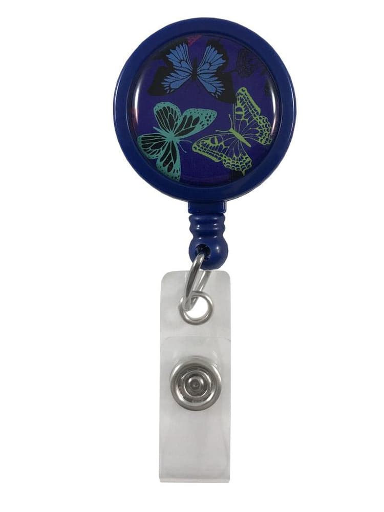 The Prestige Medical Retractable ID Holder in navy with butterfly print featuring a metal clip on the back for easy fastening to apparel on a solid white background.
