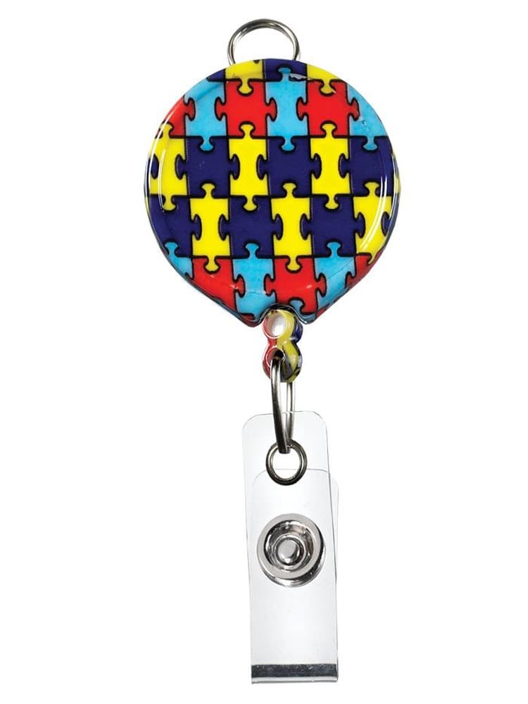 The Prestige Medical Retractable ID Holder in autism awareness puzzle pieces on a plain white background.