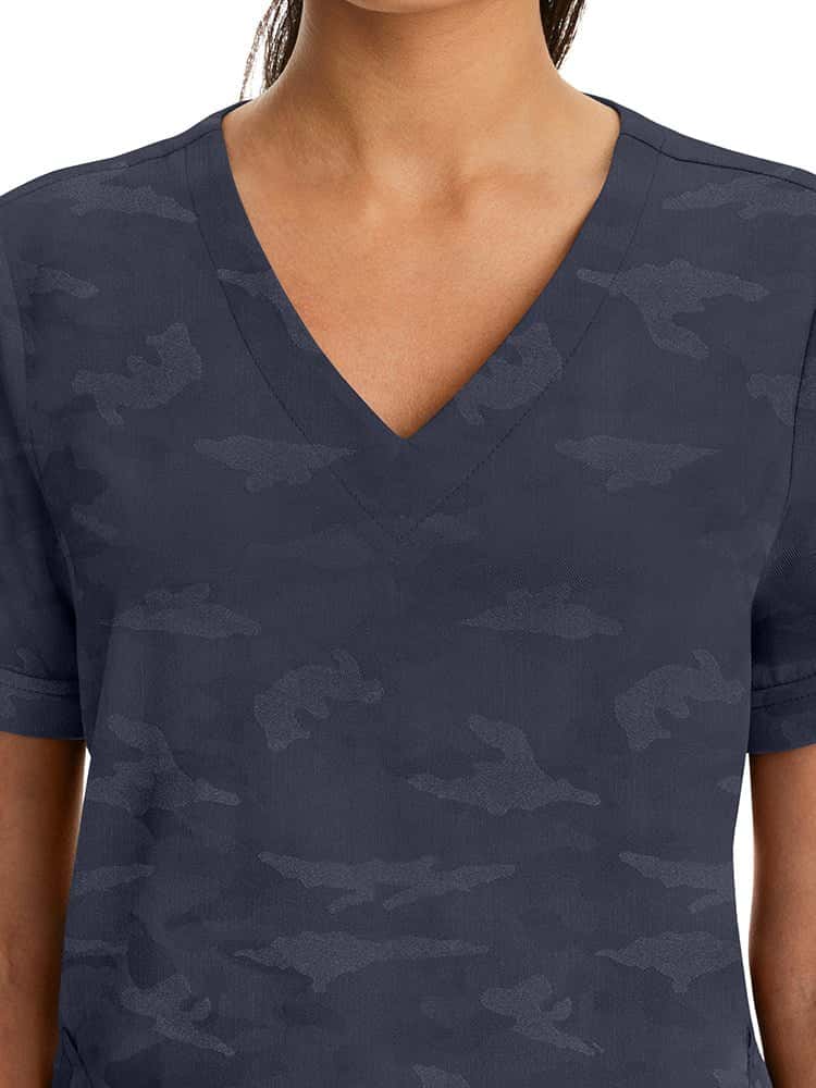 Female healthcare professional wearing a Purple Label Women's Joy Camo Top in Pewter featuring a unique Jacquard 4-Way Stretch Fabric.