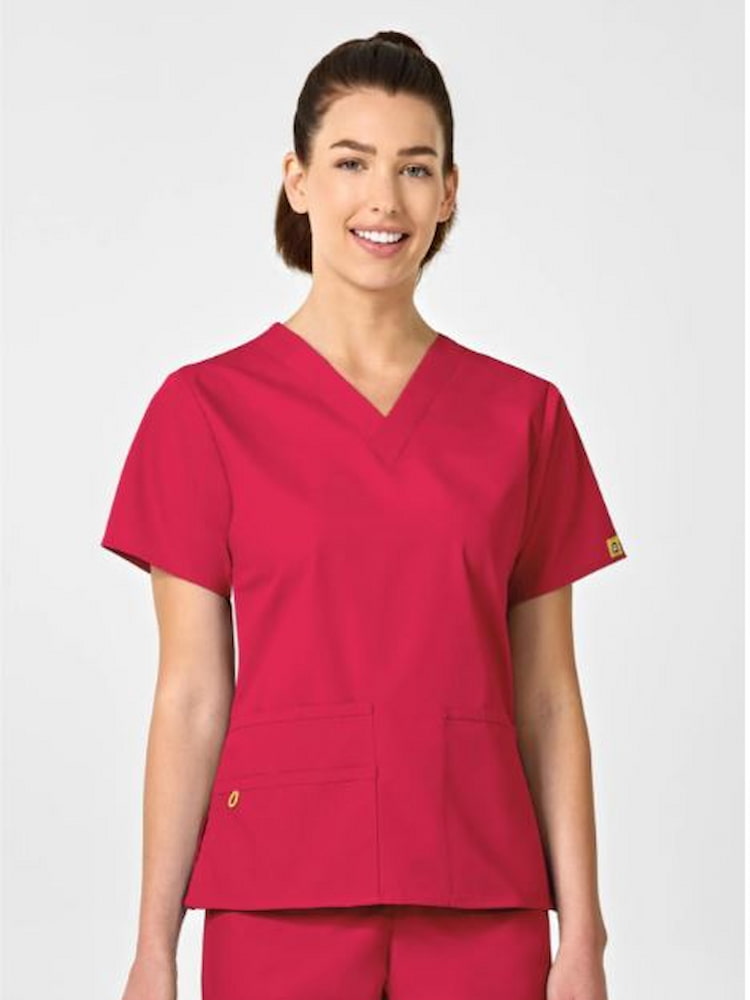 An image of a young female Midwife wearing a WonderWink Origins Women's Bravo V-neck Scrub Top in Red size Small featuring a modern fit.